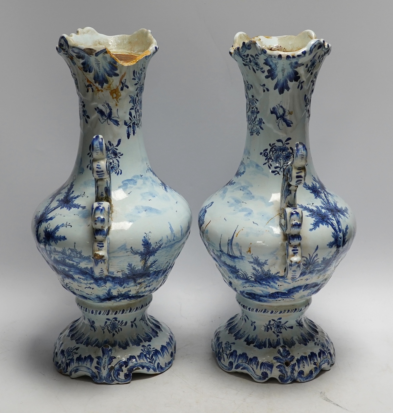 A pair of 19th century Delft blue and white vases, 35cm high. Condition - poor